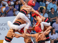 Children of Xiquets de Reus build the final part of the human tower during the Concurs de Castells competition in Tarragona, Spain, on Octob...