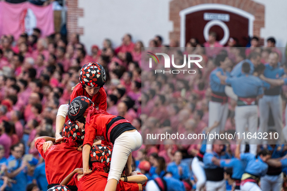 Children of the colla Castellers de Barcelona build the final part of the human tower during the Concurs de Castells competition in Tarragon...