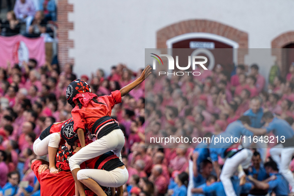 Children of the colla Castellers de Barcelona build the final part of the human tower during the Concurs de Castells competition in Tarragon...