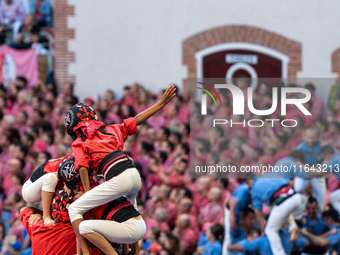 Children of the colla Castellers de Barcelona build the final part of the human tower during the Concurs de Castells competition in Tarragon...