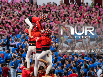 Children of the colla Castellers de Barcelona build the final part of the human tower during the Concurs de Castells competition in Tarragon...