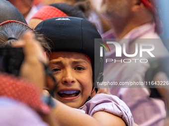 A little girl from Colla Jove Xiquets de Tarragona cries with happiness after successfully dismantling a human tower during the Concurs de C...