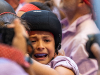 A little girl from Colla Jove Xiquets de Tarragona cries with happiness after successfully dismantling a human tower during the Concurs de C...