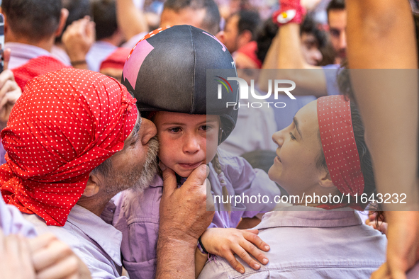 A little girl from Colla Jove Xiquets de Tarragona cries with happiness after successfully dismantling a human tower during the Concurs de C...