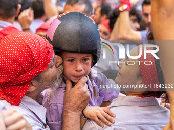 A little girl from Colla Jove Xiquets de Tarragona cries with happiness after successfully dismantling a human tower during the Concurs de C...