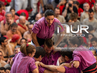 Members of the colla Moixiganguers d'Igualada build a human tower during the Concurs de Castells competition in Tarragona, Spain, on October...