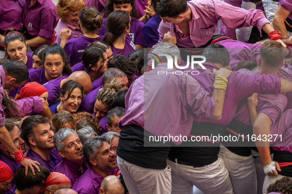 Members of the colla Moixiganguers d'Igualada celebrate the victory after building a human tower during the Concurs de Castells competition...