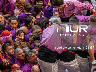 Members of the colla Moixiganguers d'Igualada celebrate the victory after building a human tower during the Concurs de Castells competition...