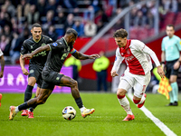 FC Groningen defender Leandro Bacuna and AFC Ajax Amsterdam forward Mika Godts play during the match between Ajax and Groningen at the Johan...