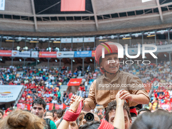 A little girl member of Xiquets de Reus cries with happiness after successfully dismantling a human tower during the Concurs de Castells com...