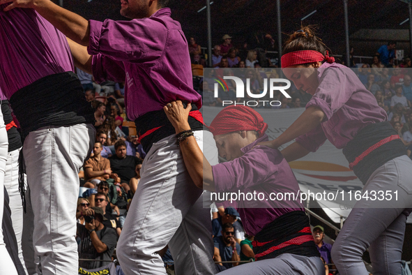 Members of the colla Moixiganguers d'Igualada build a human tower during the Concurs de Castells competition in Tarragona, Spain, on October...