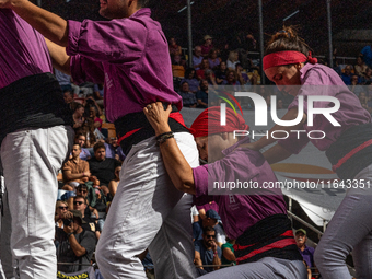 Members of the colla Moixiganguers d'Igualada build a human tower during the Concurs de Castells competition in Tarragona, Spain, on October...