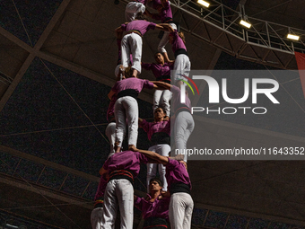 Members of the colla Moixiganguers d'Igualada build a human tower during the Concurs de Castells competition in Tarragona, Spain, on October...