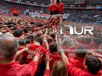 Members of Colla Joves Xiquets de Valls build a human tower during the Concurs de Castells competition in Tarragona, Spain, on October 6, 20...