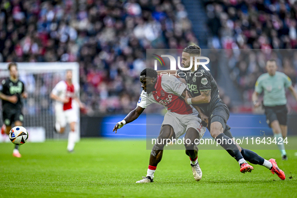 AFC Ajax Amsterdam forward Brian Brobbey and FC Groningen defender Marco Rente play during the match between Ajax and Groningen at the Johan...