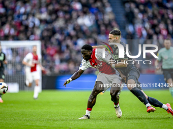 AFC Ajax Amsterdam forward Brian Brobbey and FC Groningen defender Marco Rente play during the match between Ajax and Groningen at the Johan...