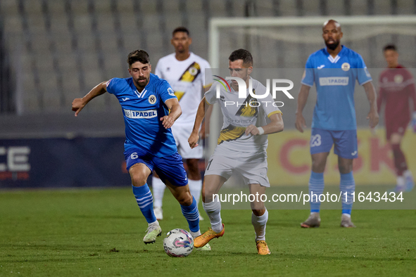 Stefan Ilic of Zabbar St. Patrick moves with the ball while Nikolai Muscat of Marsaxlokk closely attends during the Malta 360 Sports Premier...