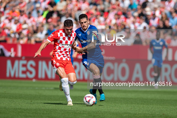 Miguel Gutierrez of Girona FC and Oihan Sancet of Athletic Club de Bilbao are in action during the LaLiga EA Sports match between Girona FC...