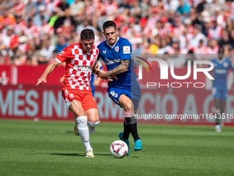 Miguel Gutierrez of Girona FC and Oihan Sancet of Athletic Club de Bilbao are in action during the LaLiga EA Sports match between Girona FC...