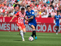 Miguel Gutierrez of Girona FC and Oihan Sancet of Athletic Club de Bilbao are in action during the LaLiga EA Sports match between Girona FC...