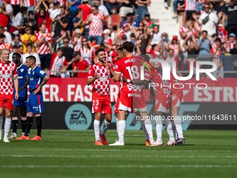 In Girona, Spain, on October 6, 2024, Girona players celebrate after scoring a goal during the LaLiga EA Sports match between Girona FC and...