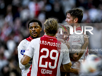 AFC Ajax Amsterdam forward Chuba Akpom, forward Christian Rasmussen, and defender Anton Gaaei celebrate the goal by forward Wout Weghorst, m...