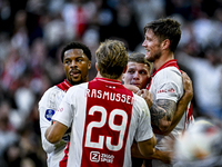 AFC Ajax Amsterdam forward Chuba Akpom, forward Christian Rasmussen, and defender Anton Gaaei celebrate the goal by forward Wout Weghorst, m...