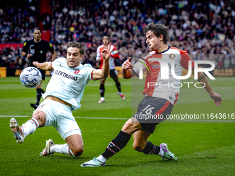 FC Twente defender Bart van Rooij and Feyenoord Rotterdam defender Hugo Bueno play during the match between Feyenoord and Twente at the Feye...