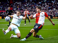 FC Twente defender Bart van Rooij and Feyenoord Rotterdam defender Hugo Bueno play during the match between Feyenoord and Twente at the Feye...