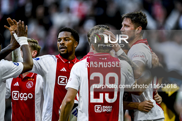 AFC Ajax Amsterdam forward Chuba Akpom, forward Christian Rasmussen, and defender Anton Gaaei celebrate the goal by forward Wout Weghorst, m...