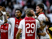 AFC Ajax Amsterdam forward Chuba Akpom, forward Christian Rasmussen, and defender Anton Gaaei celebrate the goal by forward Wout Weghorst, m...