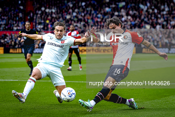 FC Twente defender Bart van Rooij and Feyenoord Rotterdam defender Hugo Bueno play during the match between Feyenoord and Twente at the Feye...