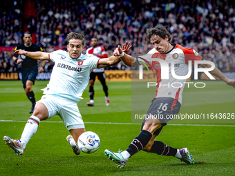 FC Twente defender Bart van Rooij and Feyenoord Rotterdam defender Hugo Bueno play during the match between Feyenoord and Twente at the Feye...