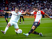 FC Twente defender Bart van Rooij and Feyenoord Rotterdam defender Hugo Bueno play during the match between Feyenoord and Twente at the Feye...