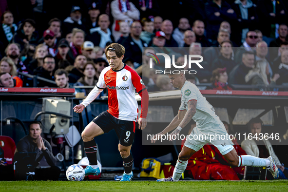 Feyenoord Rotterdam forward Ayase Ueda and FC Twente defender Mees Hilgers play during the match between Feyenoord and Twente at the Feyenoo...