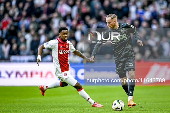 AFC Ajax Amsterdam defender Jorrel Hato and FC Groningen forward Romano Postema play during the match between Ajax and Groningen at the Joha...