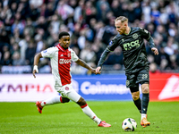 AFC Ajax Amsterdam defender Jorrel Hato and FC Groningen forward Romano Postema play during the match between Ajax and Groningen at the Joha...