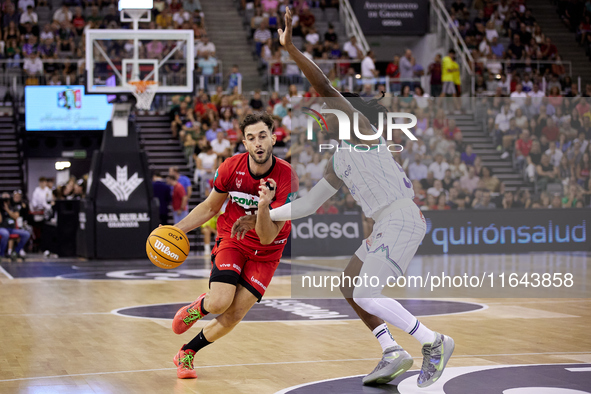 Sergi Garcia of Coviran Granada competes for the ball with Kendrick Perry of Unicaja Malaga during the Liga Endesa ACB league basketball mat...