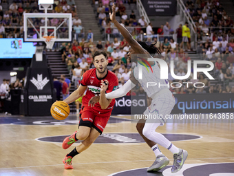 Sergi Garcia of Coviran Granada competes for the ball with Kendrick Perry of Unicaja Malaga during the Liga Endesa ACB league basketball mat...