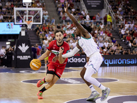 Sergi Garcia of Coviran Granada competes for the ball with Kendrick Perry of Unicaja Malaga during the Liga Endesa ACB league basketball mat...