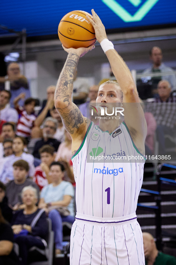 Dylan Osetkowski of Unicaja Malaga shoots a three-point basket during the Liga Endesa ACB league basketball match between Coviran Granada an...