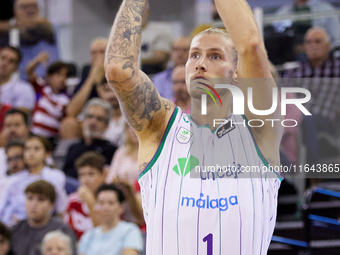 Dylan Osetkowski of Unicaja Malaga shoots a three-point basket during the Liga Endesa ACB league basketball match between Coviran Granada an...