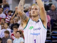 Dylan Osetkowski of Unicaja Malaga shoots a three-point basket during the Liga Endesa ACB league basketball match between Coviran Granada an...