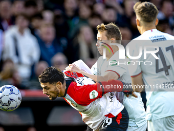 Feyenoord Rotterdam forward Santiago Gimenez and FC Twente midfielder Mathias Kjolo play during the match between Feyenoord and Twente at th...