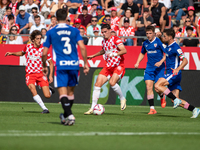 Players are in action during the LaLiga EA Sports match between Girona FC and Athletic Club de Bilbao at Montilivi Stadium in Girona, Spain,...