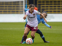 Katrina Gorry #22 of West Ham United F.C. is tackled by Yui Hasegawa #25 of Manchester City W.F.C. during the Barclays FA Women's Super Leag...