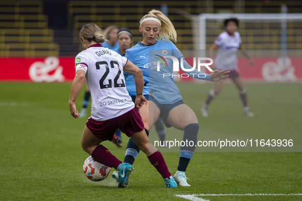 Chloe Kelly #9 of Manchester City W.F.C. tackles Katrina Gorry #22 of West Ham United F.C. during the Barclays FA Women's Super League match...