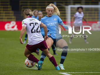 Chloe Kelly #9 of Manchester City W.F.C. tackles Katrina Gorry #22 of West Ham United F.C. during the Barclays FA Women's Super League match...