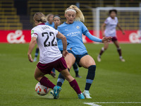 Chloe Kelly #9 of Manchester City W.F.C. tackles Katrina Gorry #22 of West Ham United F.C. during the Barclays FA Women's Super League match...