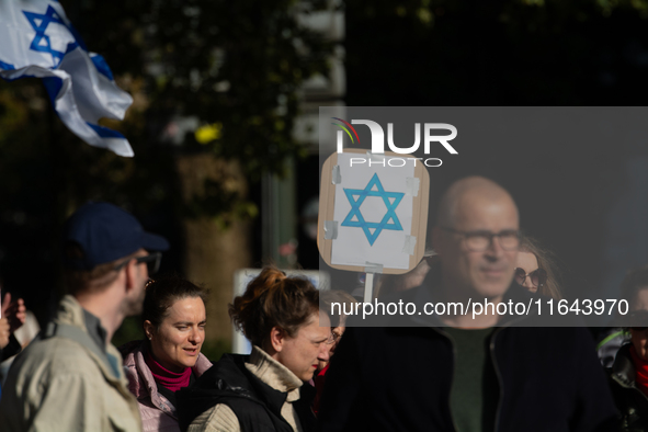 Hundreds of people take part in the ''Bring Them Home'' march to mark the first anniversary of the October 7 Hamas attack, which creates a r...